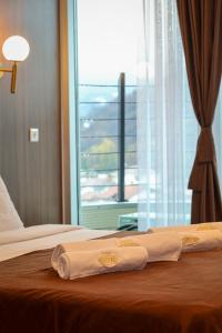 two beds in a hotel room with towels on them at Hotel Semitronix in Peje +111 photos