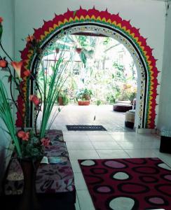 an archway in a room with flowers and plants at Homestay Tarapoto in San Antonio +11 photos