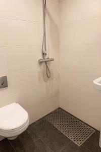 a bathroom with a toilet and a sink at PICCADILLY Private room and bathroom in Manchester