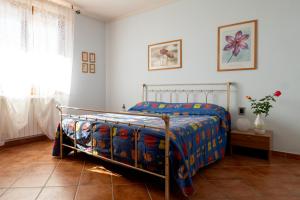 a bedroom with a bed with a colorful comforter at Villino Blu 12 pax villa in Tuscany with private pool in Loro Ciuffenna +48 photos