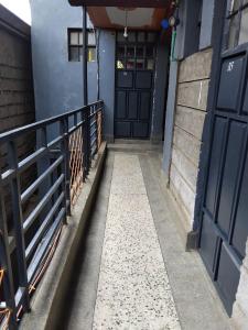 a hallway with black doors and a fence at Bliss BnB in Nairobi