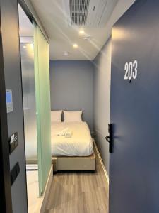 a small bedroom with a bed in a room with a door at The Hyve Budget Hotel Rotterdam in Rotterdam +26 photos