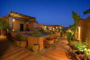 a patio with lots of potted plants on a building at BKAN RIAD MARRAKECH in Marrakesh