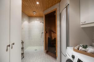 a bathroom with a walk in shower and a toilet at White Elegant Suite by the River in Rovaniemi +17 photos