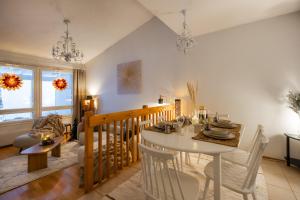 a dining room with a white table and chairs at White Elegant Suite by the River in Rovaniemi