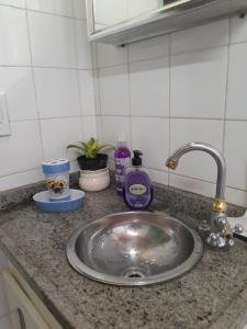 a kitchen counter with a sink in a kitchen at Recanto aconchegante próximo ao mar in Vila Velha +21 photos