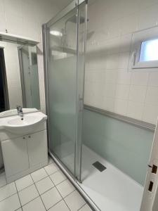 a bathroom with a shower and a sink at À deux pas de la mer in Marennes
