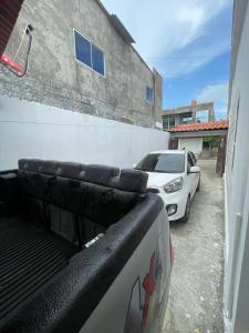 a white car is parked next to a building at Hotel Casa Colonial Moñitos in Moñitos +10 photos