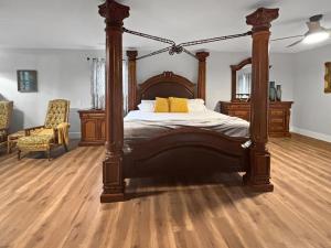 a bedroom with a canopy bed and a chair at Blindfrog in Scottsboro +59 photos
