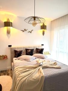 two beds in a bedroom with two birds flying overhead at AM Apartments Timișoara Comfort and Parking in Timişoara