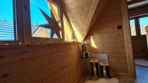 a wooden cabin with a wall with a star on it at Domki góralskie Sabałecka in Zakopane +21 photos