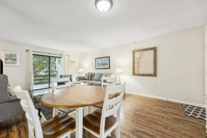 a dining room and living room with a table and chairs at 3C Amelia Landings Condo in Fernandina Beach
