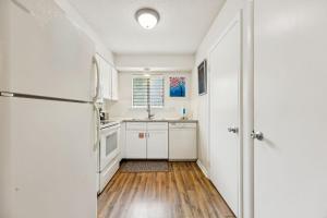a kitchen with white cabinets and a refrigerator at 3C Amelia Landings Condo in Fernandina Beach