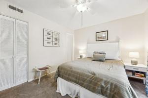 a bedroom with a bed and a ceiling fan at 3C Amelia Landings Condo in Fernandina Beach +20 photos