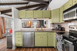 a kitchen with green cabinets and a sink at Chic 2 BD 2 BA Near Skiing Fireplace etc in Pocono Pines +51 photos