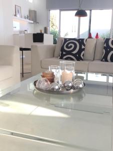 a tray of cookies and candles on a table in a living room at Katikies Grand - Superior Villa Adults Only in Pissouri +47 photos