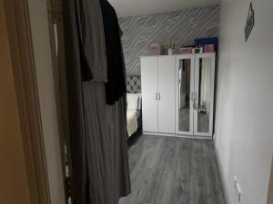 Habitación con cama y armario blanco en Guest Home, en Birmingham