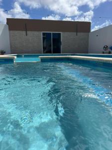 a swimming pool with blue water in front of a building at Mary's Villas Private Pool In Noord in Noord