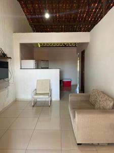 a living room with a couch and a chair at Casa em Porto de pedras in Tatuamunha +11 photos