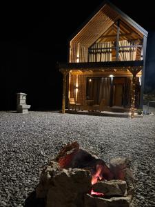 a house with a fire pit in front of it at Driftwood Dreams in Cetinje