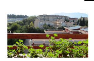 a view of a city from behind a wooden fence at La Roseraie in Battipaglia