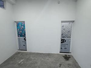 a white wall with three windows in a room at Mark International in Colombo
