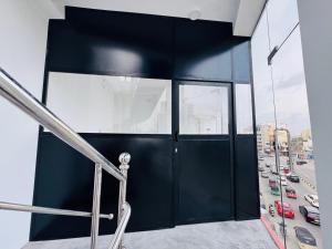 a black door in a building with a view of a city at Mark International in Colombo