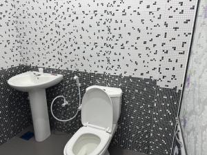 a bathroom with a toilet and a sink at Mark International in Colombo