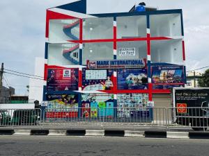 a large building with signs on the side of a street at Mark International in Colombo