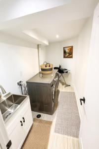a kitchen with a sink and a stove at Luxury, Brand-new, Specious, 2-Bedroom Apartment in Richmond Hill