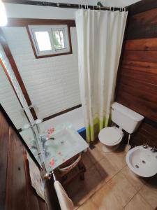 a bathroom with a sink and a toilet at La Posada del Mar in Miramar