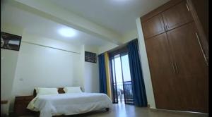 En eller flere senge i et værelse på Lake Victoria Grand View