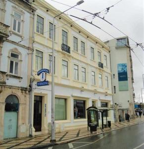 a building on the side of a street with a bus stop at Internacional in Coimbra