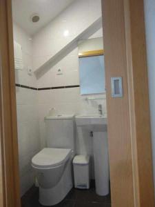 a bathroom with a white toilet and a sink at Internacional in Coimbra +34 photos