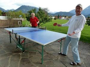 a man standing in front of a ping pong table at Landhaus Panorama in Reutte