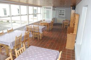 an empty restaurant with tables and chairs and windows at The Castle Bed & Breakfast in Ballintoy