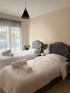 een slaapkamer met twee bedden met handdoeken erop bij Angelo Maison in Thessaloniki