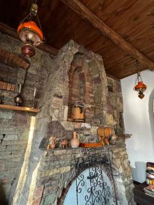a stone fireplace with pots and pans on it at Vintage Villa Mitskheta in Mtskheta +16 photos