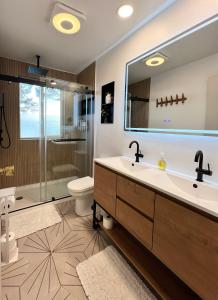 a bathroom with a sink and a shower at THE SHORELINE #1 - Ocean Views and Northern Lights in Kodiak