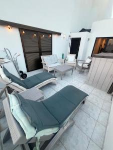 a patio with chairs and a table on a balcony at Sea View Penthouse with Large Terrace in Los Cristianos