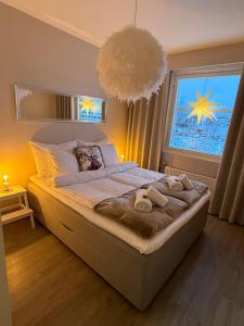 a bedroom with a large bed with a large window at Your Lapland Adventure Base in Rovaniemi