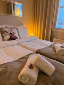 a hotel room with two beds with towels on them at Your Lapland Adventure Base in Rovaniemi