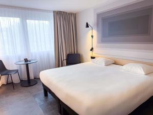 Ένα ή περισσότερα κρεβάτια σε δωμάτιο στο Ibis Alès Centre Ville