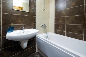 a bathroom with a sink and a bath tub at Blue Nest Studio - Free Parking and Mountain View in Razlog +12 photos