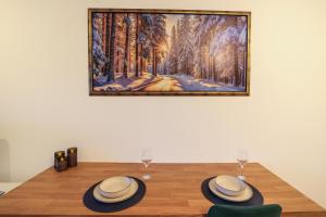 a dining room table with two hats and wine glasses at Blue Nest Studio - Free Parking and Mountain View in Razlog