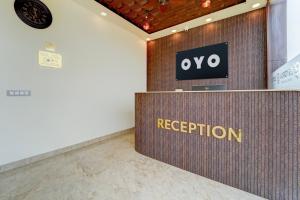 a reception desk in a room with a sign on it at Hotel O ESTORIA HOTEL & RESORT in Kadakola +23 photos