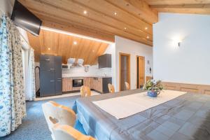 a dining room with a table and a kitchen at Landhaus Dajana in Gaschurn