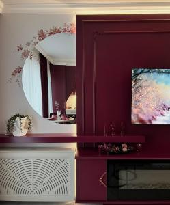 a living room with a mirror and a tv at Bridge Apartment & Jacuzzi in Timişoara