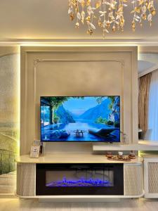 a large television in a living room with a fireplace at Bridge Apartment & Jacuzzi in Timişoara +133 photos