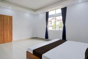 Ένα ή περισσότερα κρεβάτια σε δωμάτιο στο Hotel O Happy Homes Resort